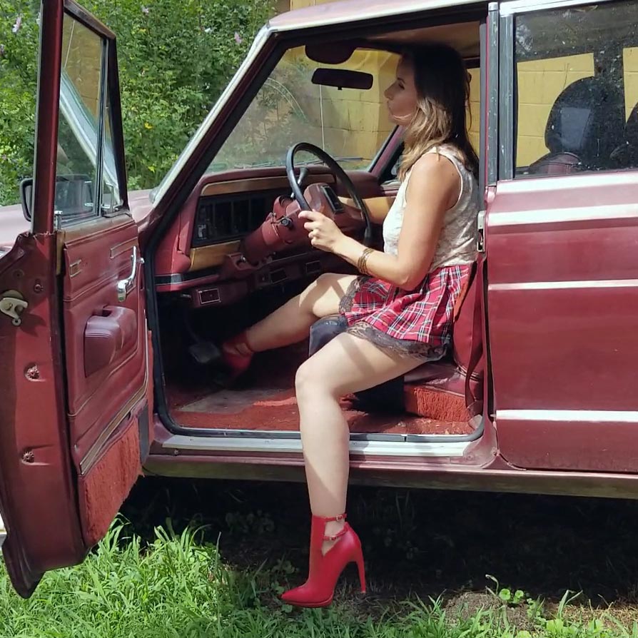 Vassanta Cranking the Jeep in Plaid Skirt & Red Booties